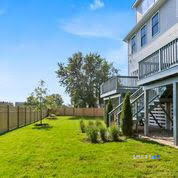 995 Reef Road Fairfield, CT 06824 - Photo 12 of 14 a view of a house with a yard and plants