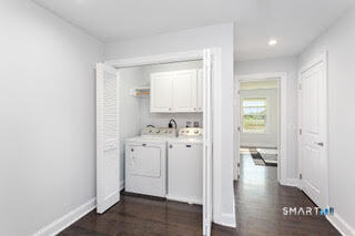995 Reef Road Fairfield, CT 06824 - Photo 6 of 14 a view of a hallway with bathroom and wooden floor
