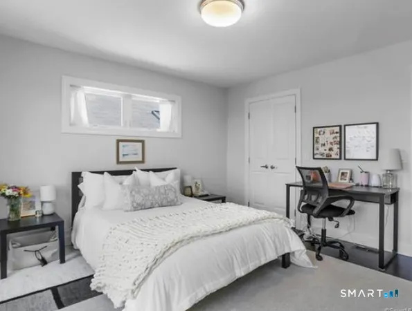 a bedroom with a bed and a table in it