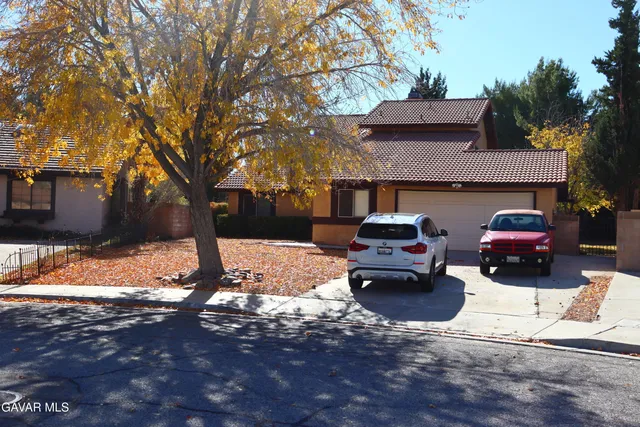 a front view of a house with a yard covered in snow
