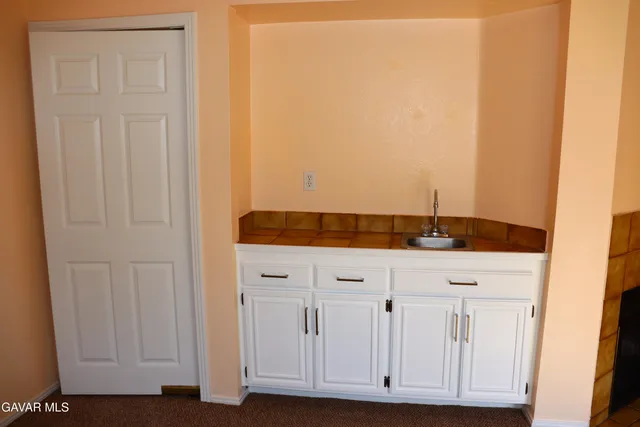 a view of bathroom with granite countertop cabinets