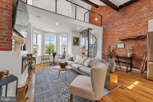 a living room with furniture a dining table and chairs with wooden floor