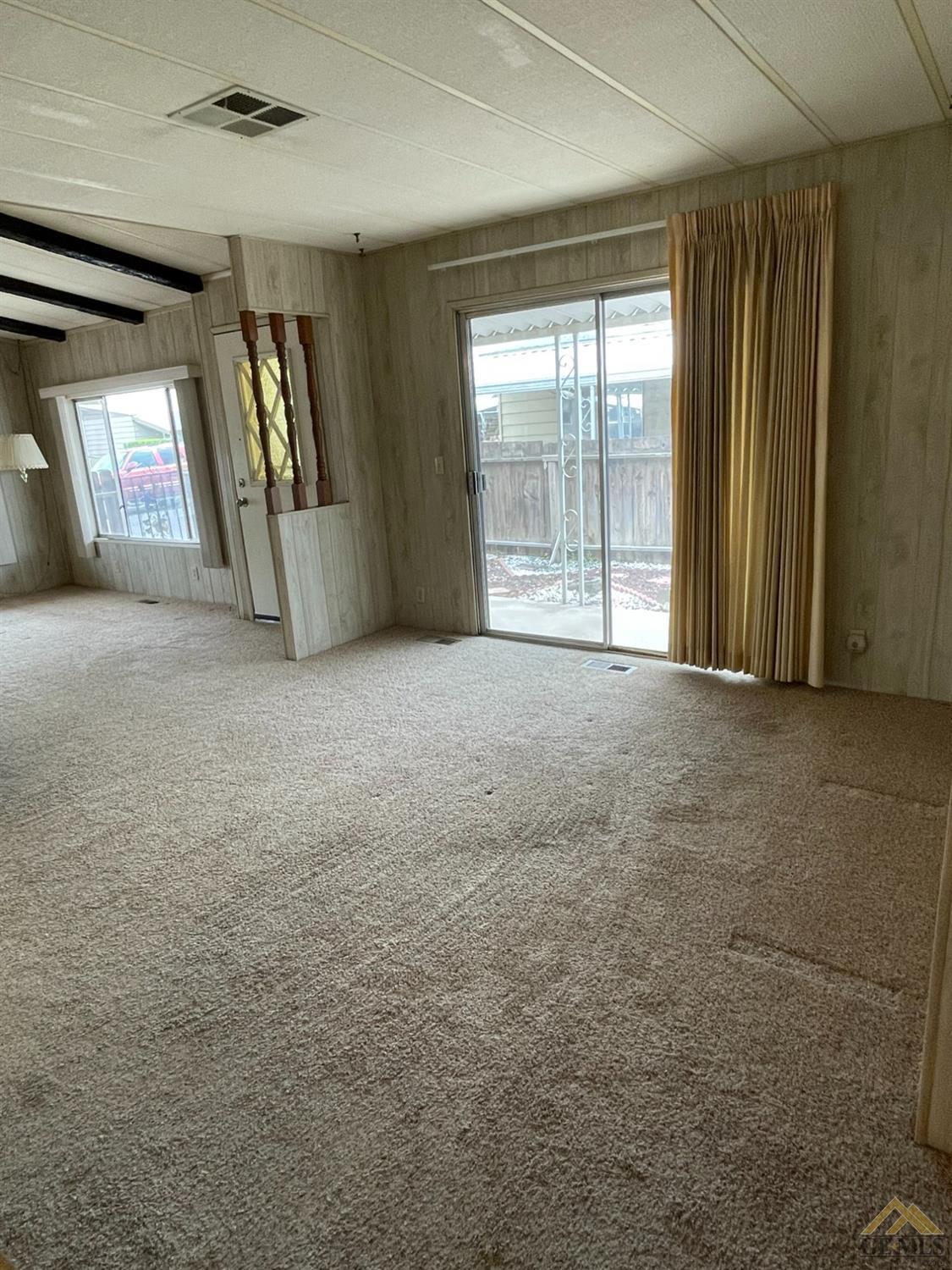 Undisclosed Address Bakersfield, CA 93308 - Photo 11 of 40 a view of an empty room with glass door and windows