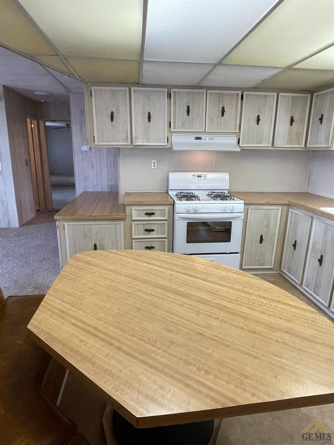 Undisclosed Address Bakersfield, CA 93308 - Photo 15 of 40 a kitchen with granite countertop white cabinets and stainless steel appliances