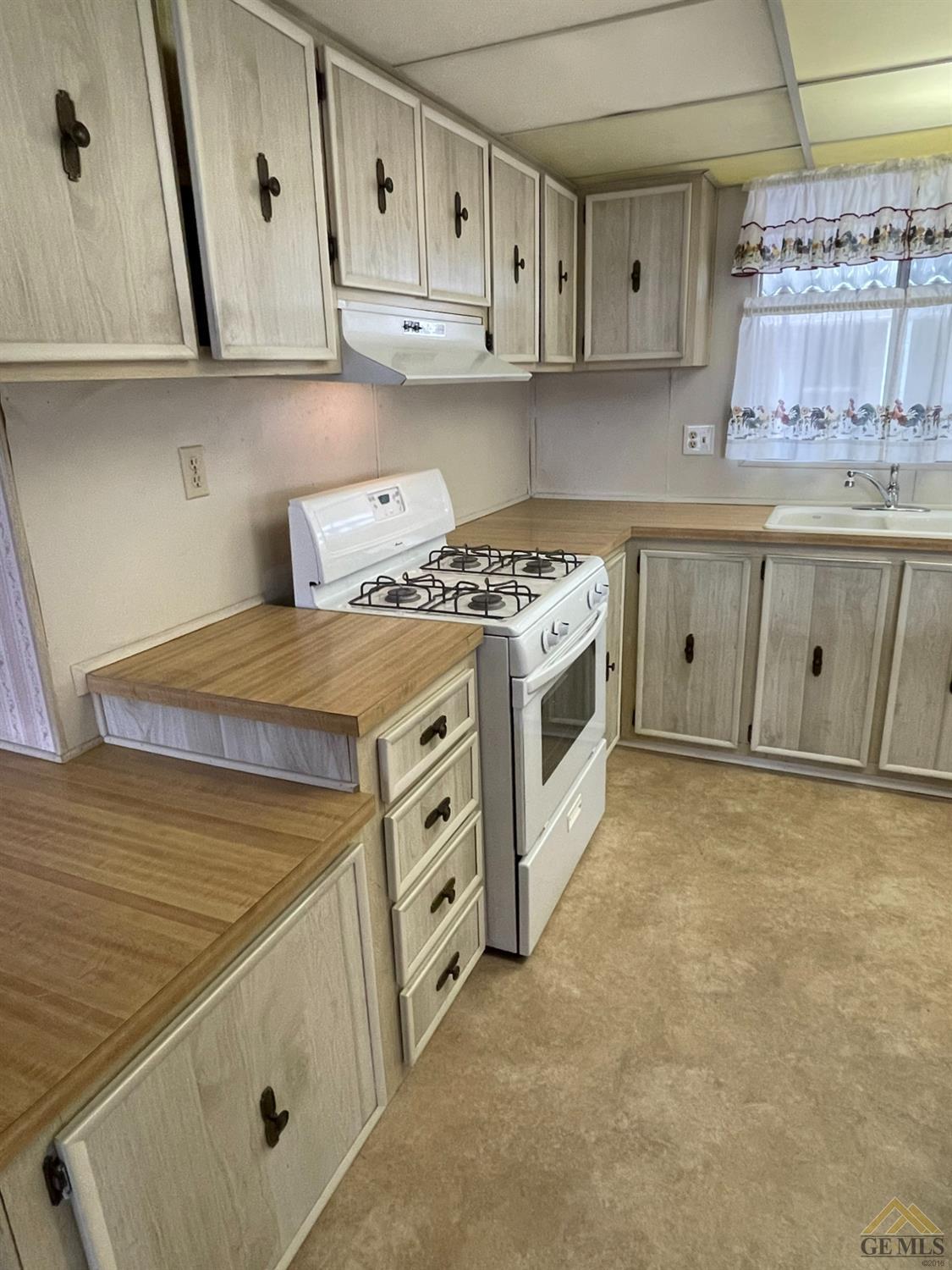 Undisclosed Address Bakersfield, CA 93308 - Photo 18 of 40 a kitchen with stainless steel appliances granite countertop a stove and a sink