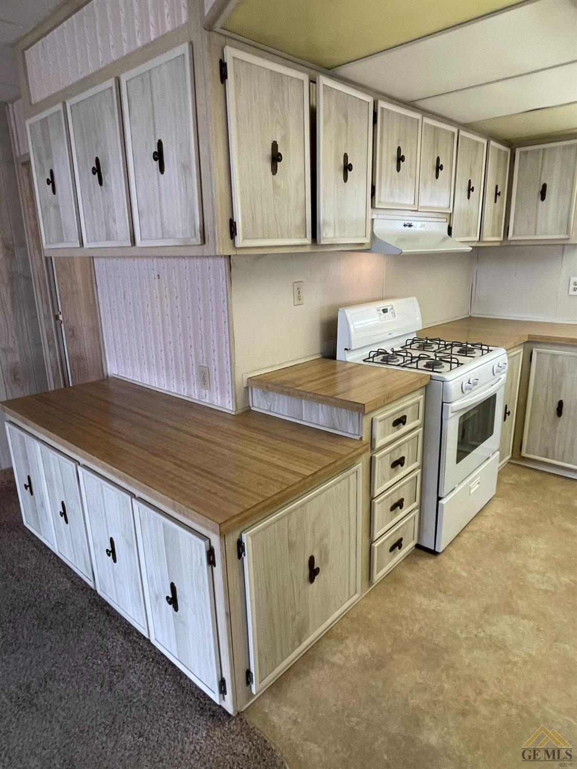 Undisclosed Address Bakersfield, CA 93308 - Photo 19 of 40 a kitchen with granite countertop a stove and a sink