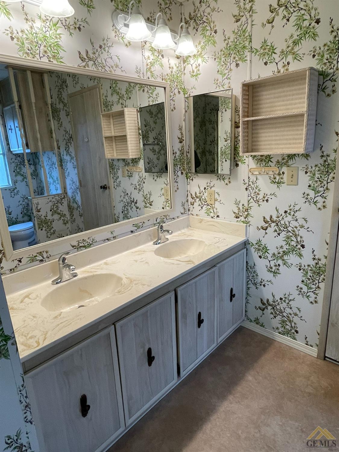 Undisclosed Address Bakersfield, CA 93308 - Photo 29 of 40 a bathroom with double vanity sink and mirror