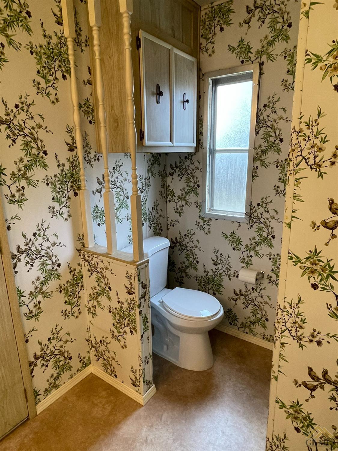 Undisclosed Address Bakersfield, CA 93308 - Photo 33 of 40 a bathroom with a toilet and a shower curtain