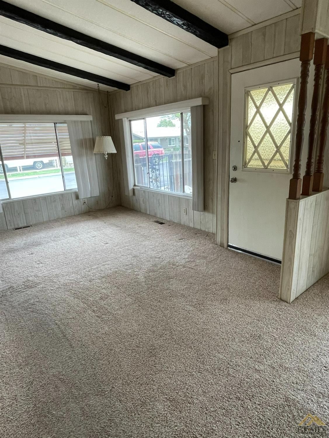 Undisclosed Address Bakersfield, CA 93308 - Photo 6 of 40 a view of an empty room with a fireplace and a window