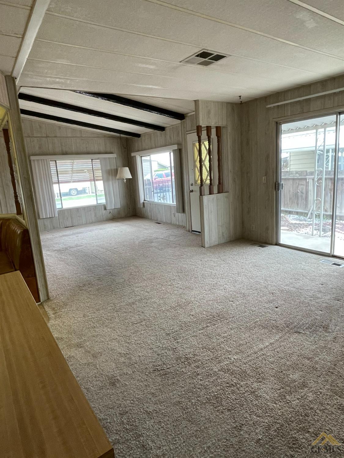 Undisclosed Address Bakersfield, CA 93308 - Photo 10 of 40 a view of an empty room with a fireplace and a large window