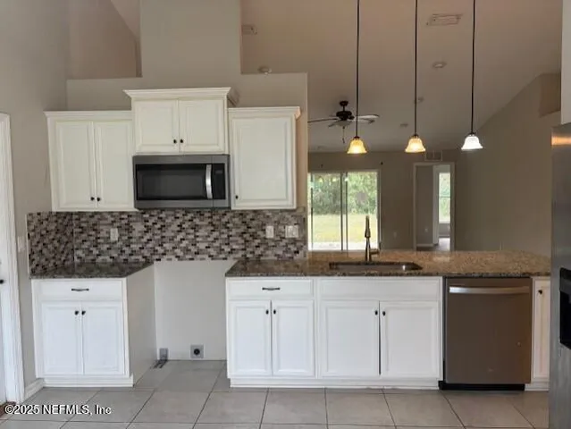 a kitchen with white cabinets