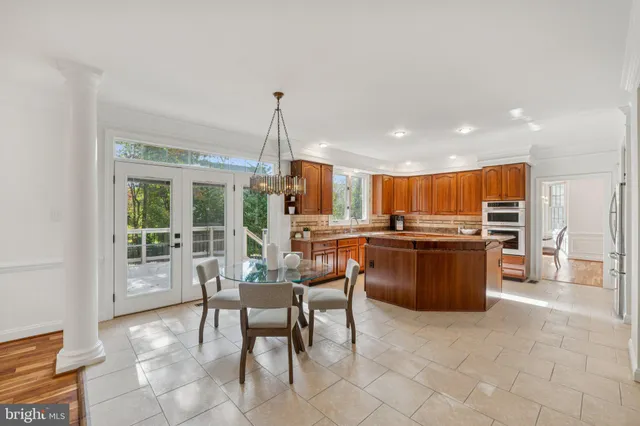 a kitchen with a table and chairs in it