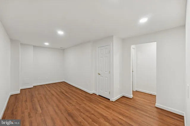 a view of a room with wooden floor
