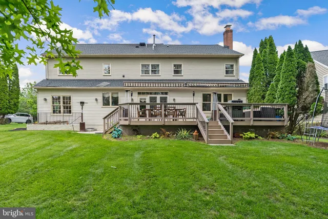 a view of a house with a yard and sitting area