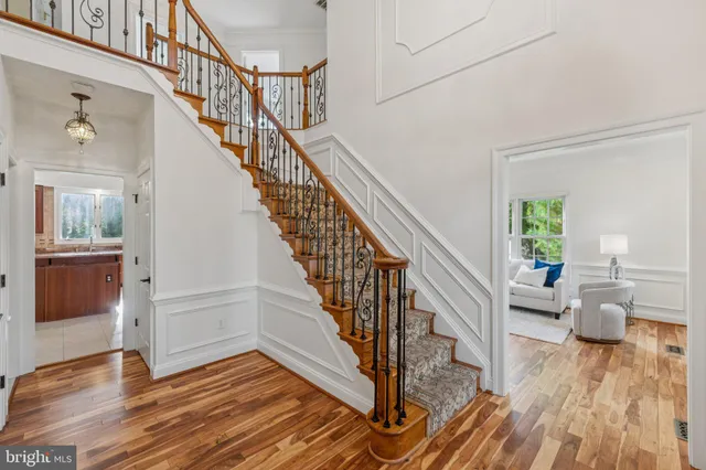 a view of entryway and hall with wooden floor