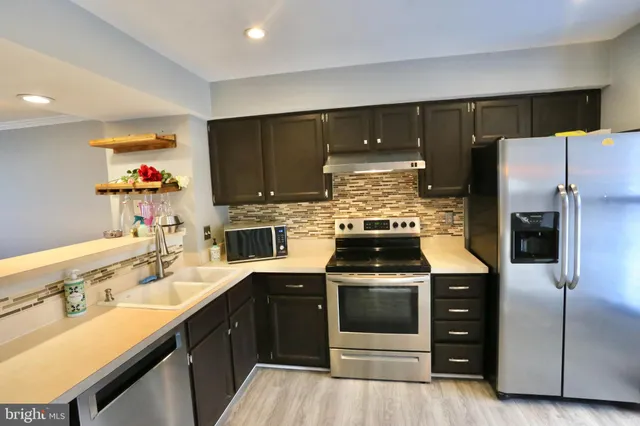a kitchen with a sink stove and refrigerator