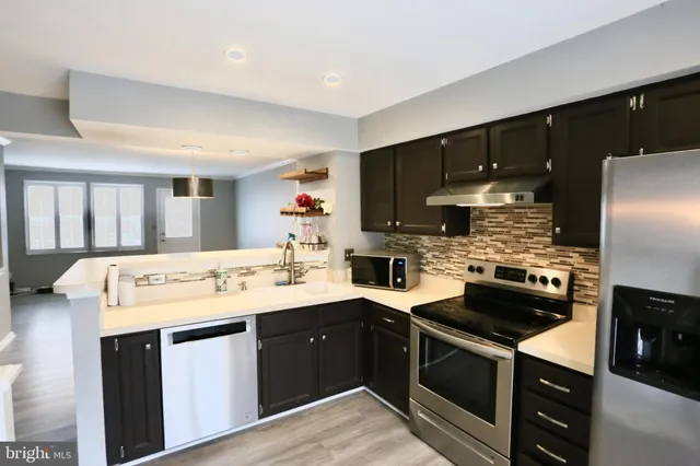 a kitchen with a sink a stove and cabinets