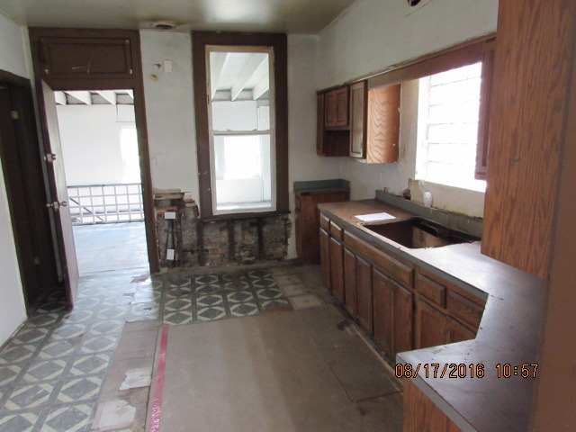 1915 South Pulaski Road Chicago, IL 60623 - Photo 11 of 14 a kitchen with a stove a sink and a refrigerator