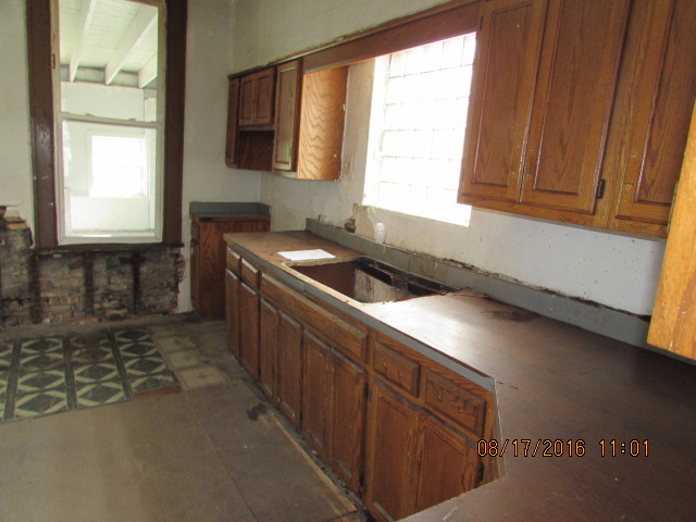 1915 South Pulaski Road Chicago, IL 60623 - Photo 13 of 14 a kitchen with a sink a window and cabinets