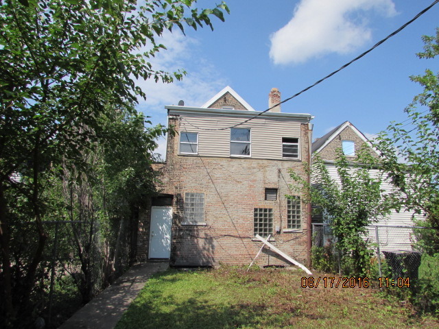 1915 South Pulaski Road Chicago, IL 60623 - Photo 3 of 14 a front view of a house with a yard