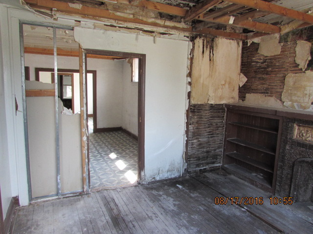 1915 South Pulaski Road Chicago, IL 60623 - Photo 7 of 14 a view of an empty room with wooden floor and a window