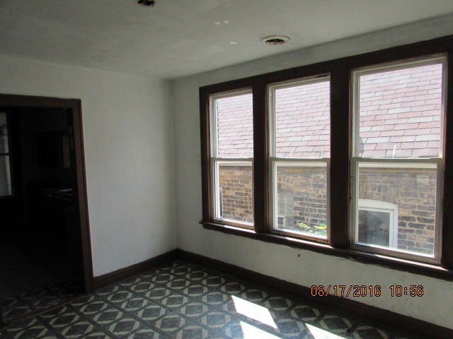 1915 South Pulaski Road Chicago, IL 60623 - Photo 9 of 14 a view of an empty room with a window