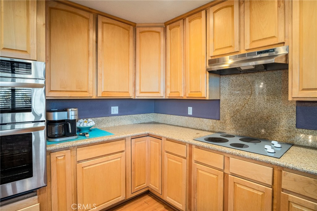 388 Calaveras Road Pinon Hills, CA 92372 - Photo 11 of 44 a kitchen with stainless steel appliances granite countertop a sink a stove cabinets and a microwave oven