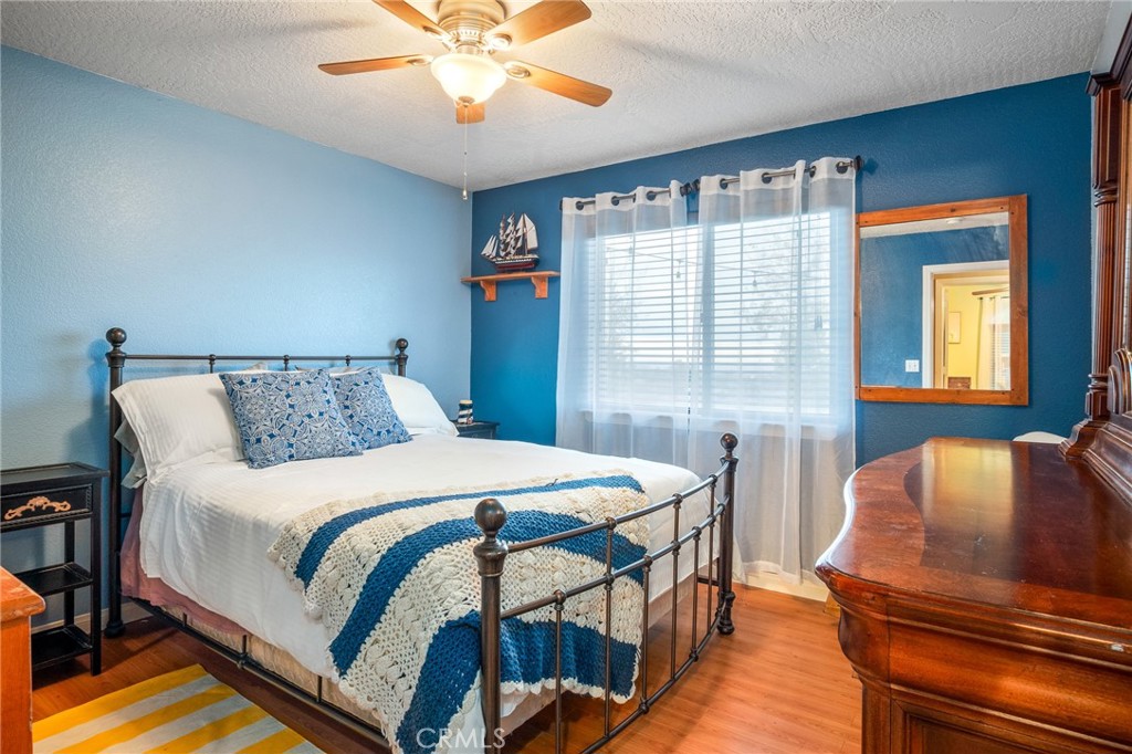 388 Calaveras Road Pinon Hills, CA 92372 - Photo 20 of 44 a bedroom with a bed and wooden floor