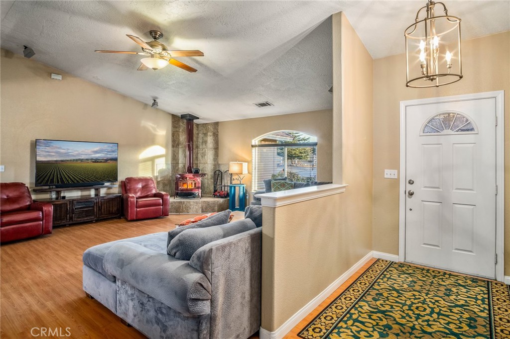 388 Calaveras Road Pinon Hills, CA 92372 - Photo 3 of 44 a living room with furniture and a chandelier
