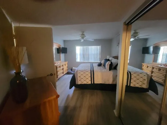 a view of a bedroom with furniture and wooden floor