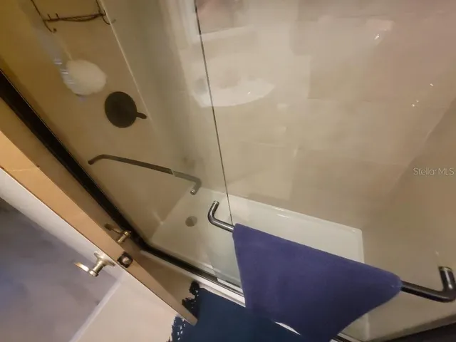 a bathroom with a glass shower door