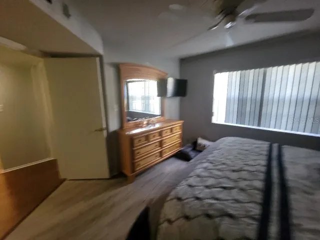 a bedroom with a bed and painting on the wall