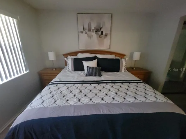 a bedroom with a bed and window