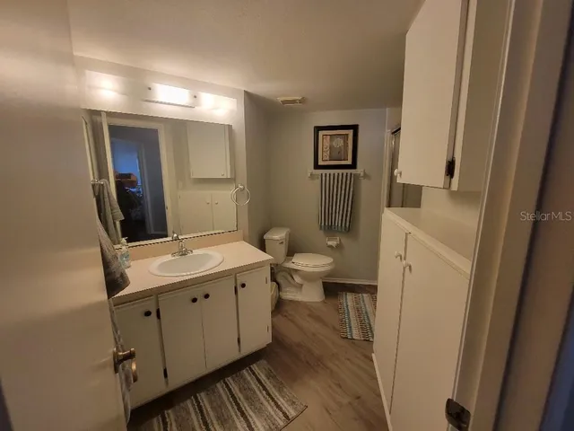 a bathroom with a toilet a sink and mirror