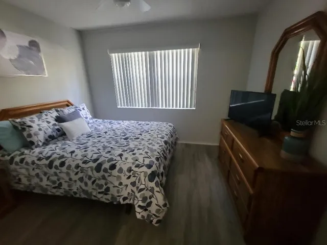 a bed sitting in a bedroom next to a window