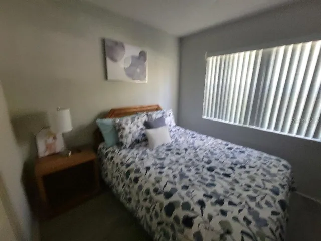 a bedroom with a bed and a television