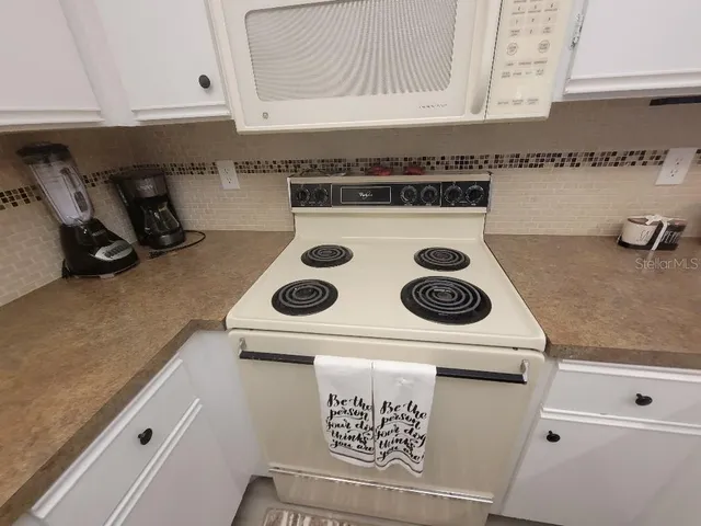 a large bedroom with a bed and wooden floor