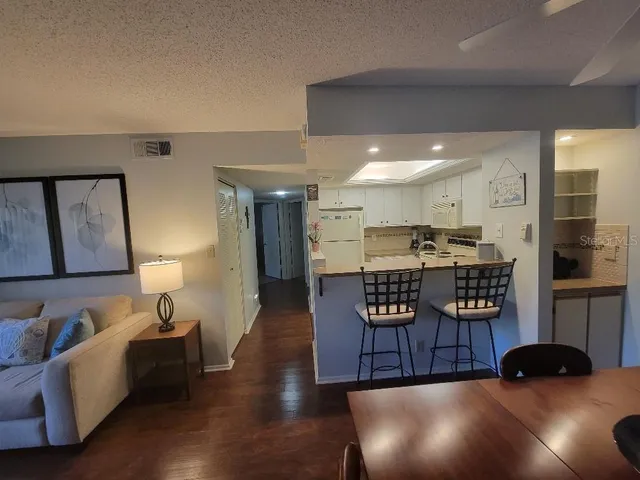 a living room with furniture and a book shelf