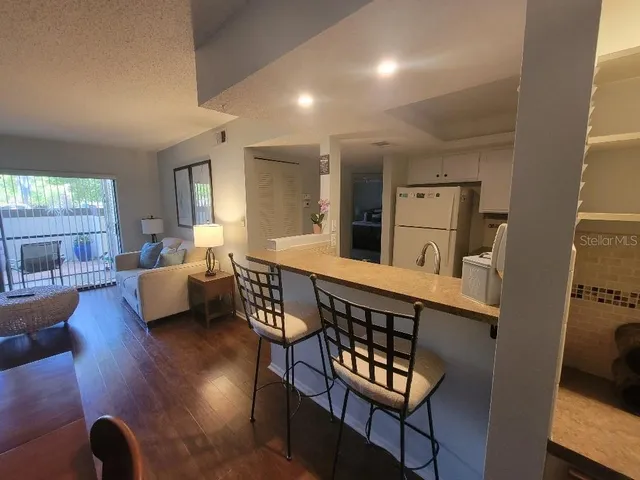 a kitchen with a table chairs and a refrigerator