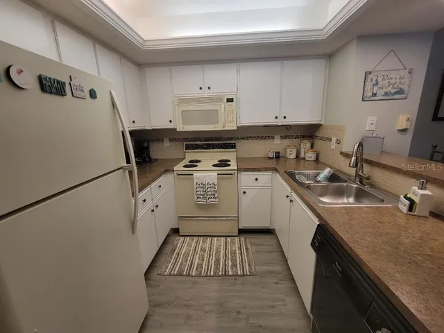 a kitchen with a sink a stove and cabinets