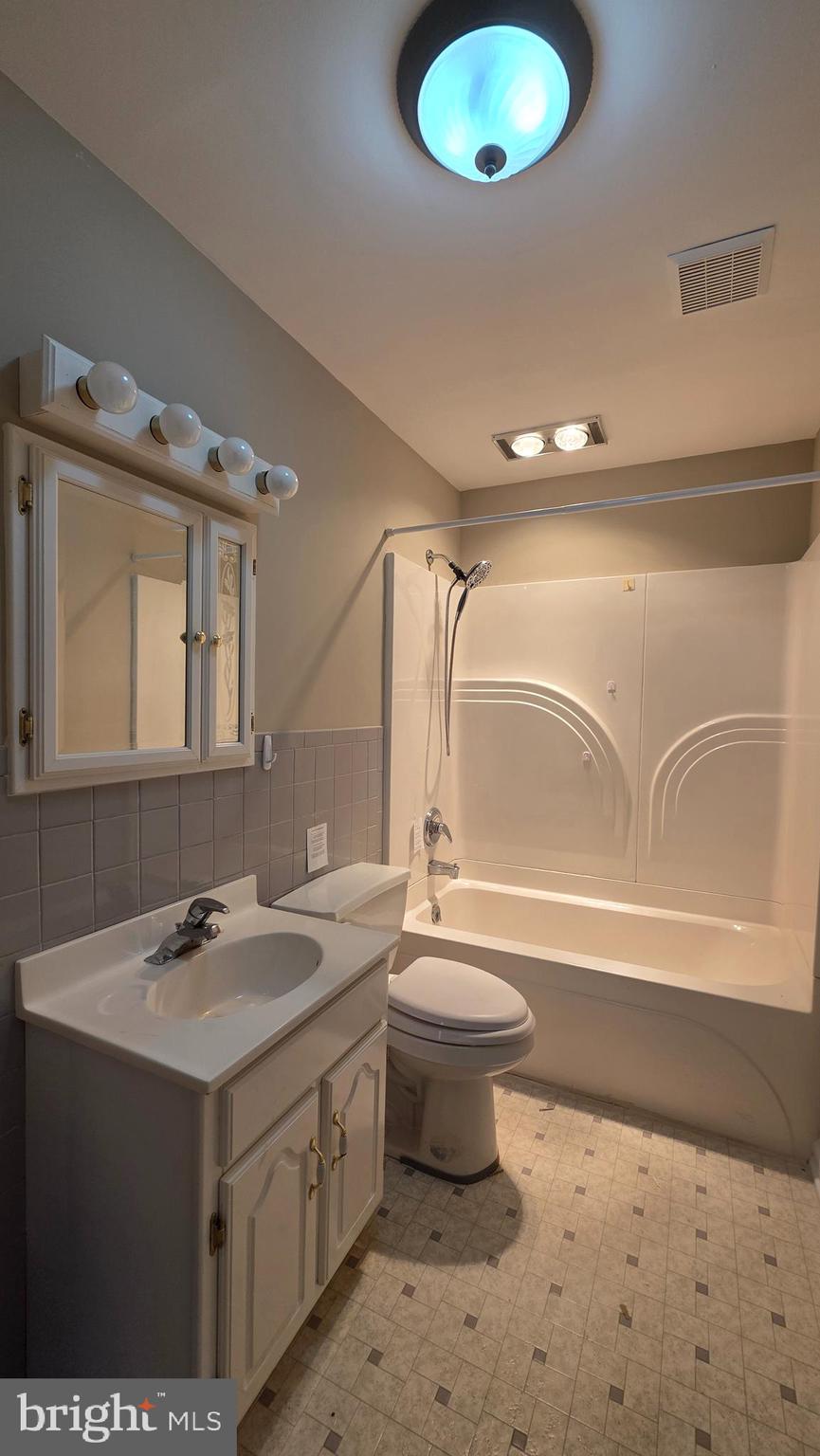 6125 Fishers Station Road Lothian, MD 20711 - Photo 16 of 23 a bathroom with a sink and a mirror