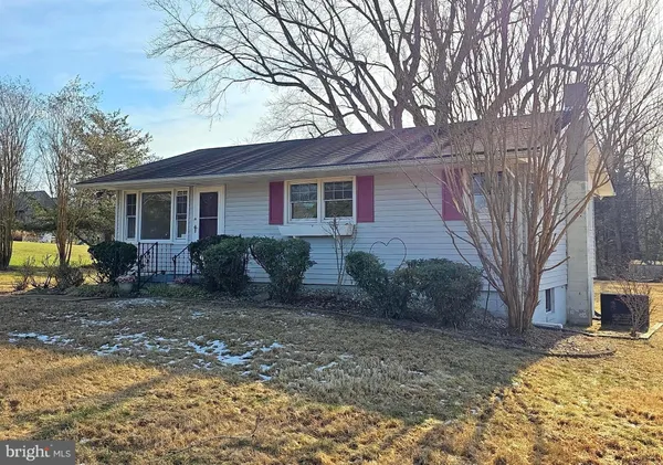 a view of a house with a yard covered in snow