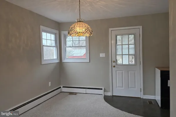 a kitchen with a refrigerator and a stove top oven