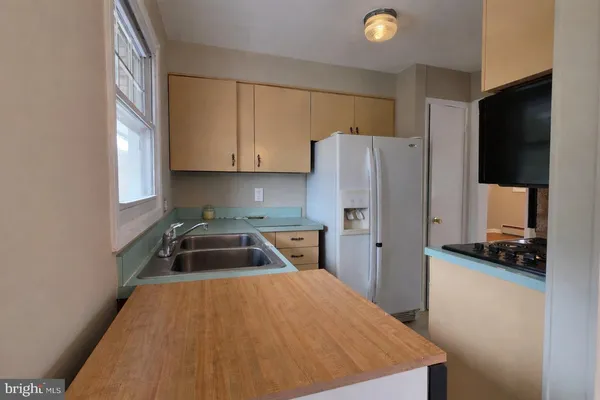 a kitchen with a refrigerator and a sink