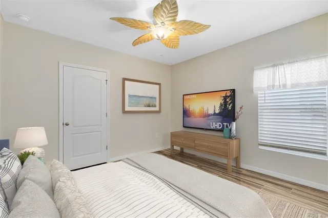 a bedroom with a bed and a chandelier