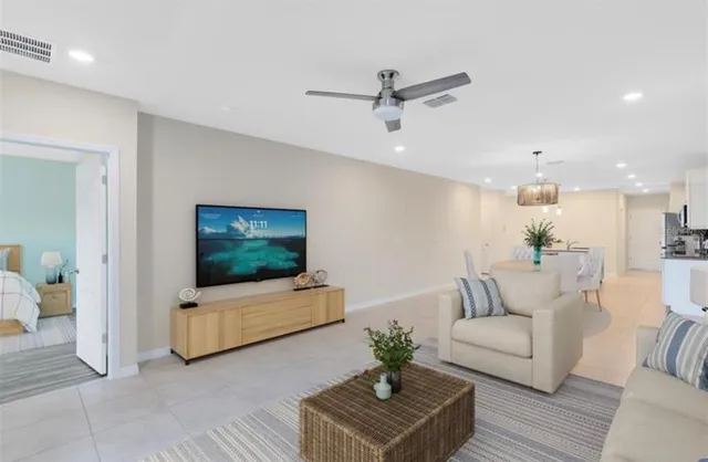 a living room with furniture and wooden floor