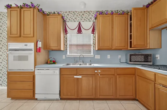 a kitchen with white cabinets and a sink