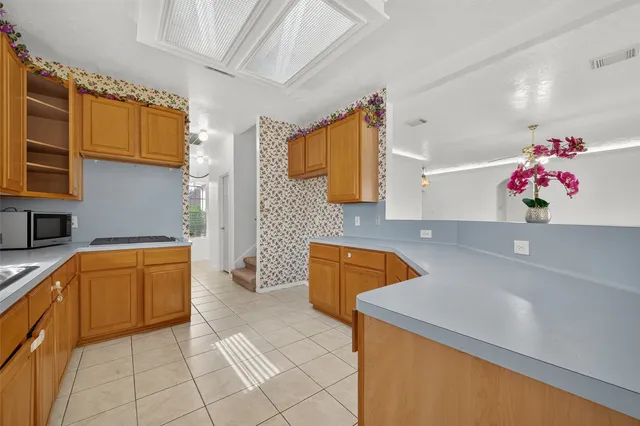 a kitchen with a sink dishwasher stove top oven and microwave
