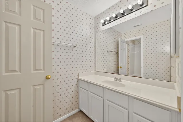 a bathroom with a sink a vanity and a mirror