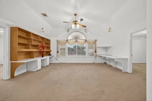 a view of an empty room with a cabinet and a fireplace